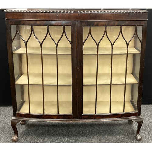 70 - An Edwardian mahogany bow-front display cabinet, glazed doors and sides enclosing three tiers of she... 