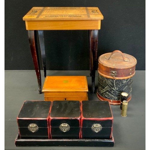 112 - Boxes & Objects - A set of three Japanese cinnabar coloured and black caddies or boxes with stand;  ... 