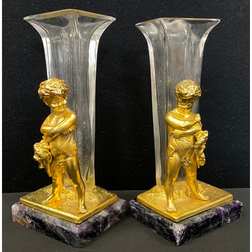 114 - A pair of gilt metal and glass figural spill vases, as Bacchanalian figures holding Masks, stood bef... 