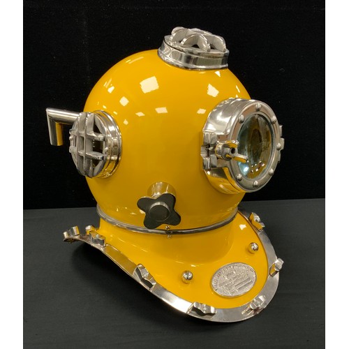 134 - A reproduction novelty yellow divers helmet, marked ‘US NAVY DIVING HELMET’, 43cm high