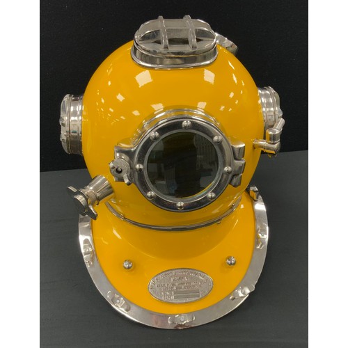 134 - A reproduction novelty yellow divers helmet, marked ‘US NAVY DIVING HELMET’, 43cm high