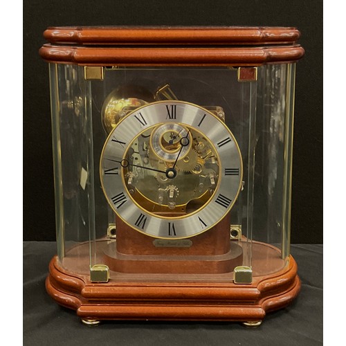 199 - A Franz Hermle part skeleton dial mantel clock, model number number 352-070, the shaped glass case e... 