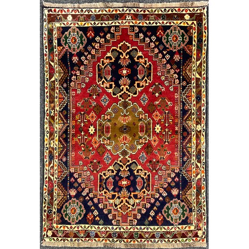 206 - A South West Persian Qashgai rug / carpet, hand-knotted with a central row of three medallions, with... 