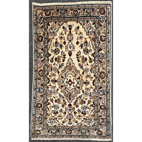 225 - A Central Persian Kashan rug / carpet, hand-knotted in subdued earthy tones, accented in blue, with ... 