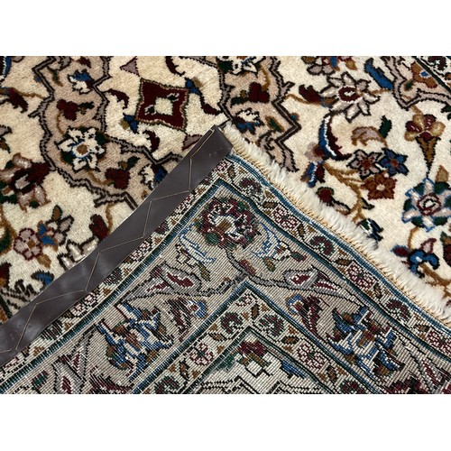 225 - A Central Persian Kashan rug / carpet, hand-knotted in subdued earthy tones, accented in blue, with ... 