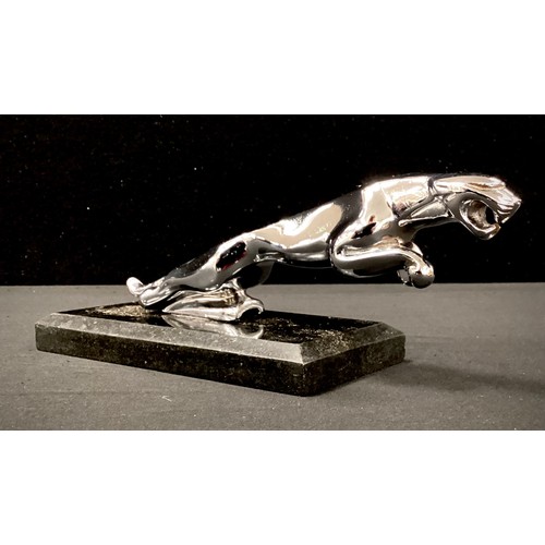 252 - A replica silver coloured car mascot as a Jaguar on black marble plinth, 15cm long