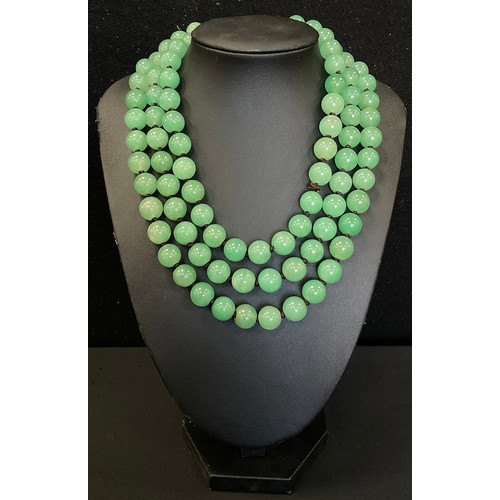 339 - A string of green jade effect beads, 68cm long