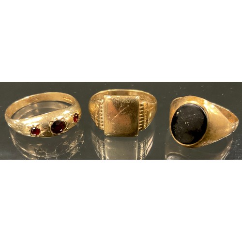 364 - A garnet set 9ct gold three stone ring, size X, 3.2g gross;  another black onyx oval size T, 2.9g gr... 