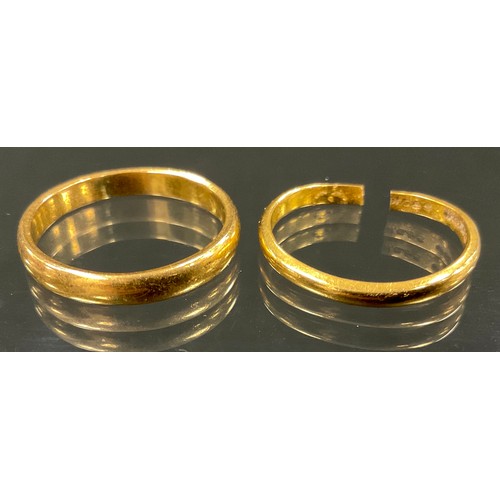 376 - A 22ct gold wedding band, size U, another cut, 8.4g (2)