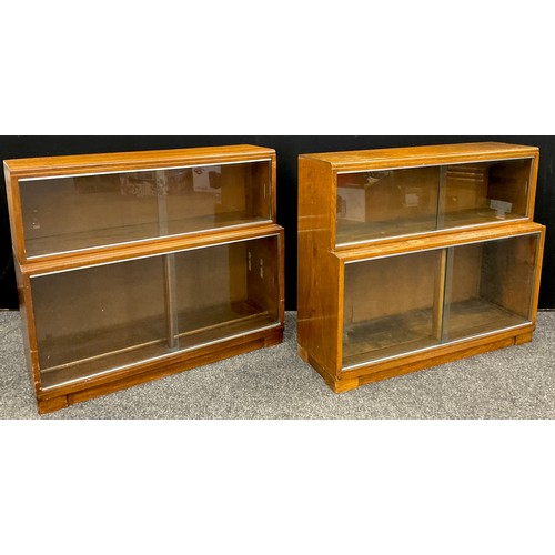 136 - A ‘Minty’ oak two-tier bookcase with sliding glass doors;  and a matching ‘Minty’ bookcase in walnut... 