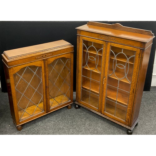 146 - An early 20th century oak bookcase cabinet, quarter galleried top, carved decoration to frieze, glaz... 