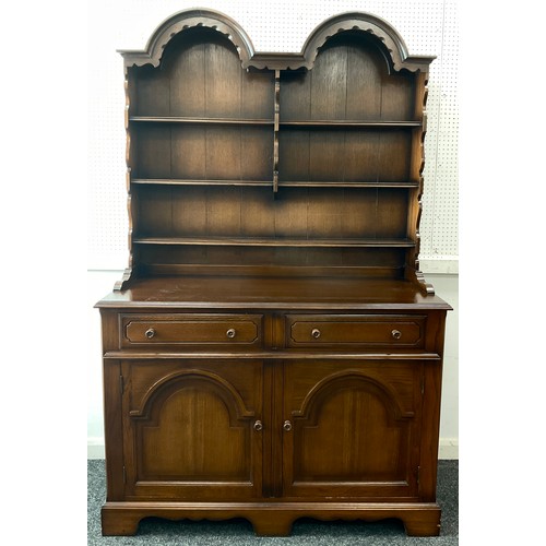 149 - An oak double-arch-top dresser, plate rack top having three tiers of shelving, above two short drawe... 