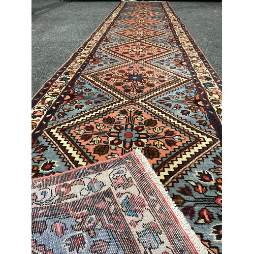 157 - A North West Persian Rudbar Runner carpet, hand-knotted with a row of nine diamond-shaped medallions... 