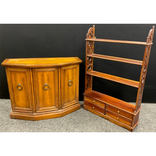 187 - A mahogany wall-mounted four tier shelf, with four short drawers to base, fretwork sides, 113cm high... 