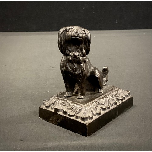 212 - A Bronze cast iron weighted desk weight, as a seated Spaniel, floral plinth, 7.6cm high, c.1920