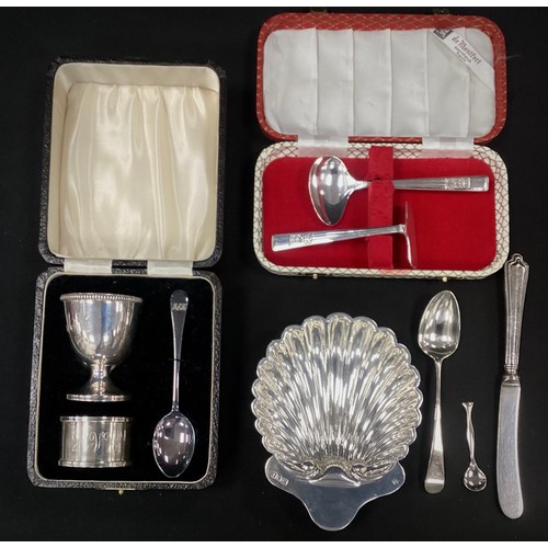 267 - Silver Shell shaped sweet meat dish, London,1904; egg holder, spoon, napkin ring set, Birmingham, 19... 