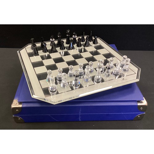 263 - A Swarovski chess set - Black and clear cut crystal, mirror chess board in original case, certificat... 