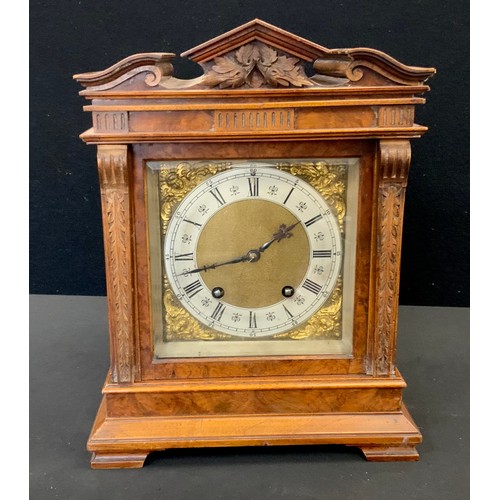 185A - A Lenzkirch Walnut cased Black Forest mantel clock, carved architectural pediment, the brass and sil... 