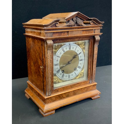 185A - A Lenzkirch Walnut cased Black Forest mantel clock, carved architectural pediment, the brass and sil... 