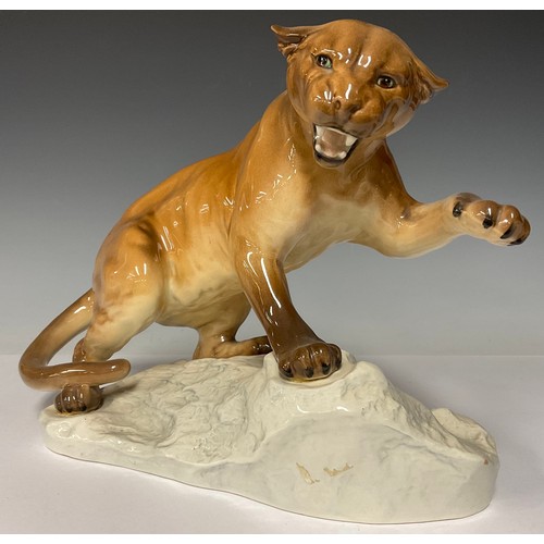 75 - A Beswick model of a puma on a rocky outcrop, number 1702, 29cm wide, printed and impressed marks