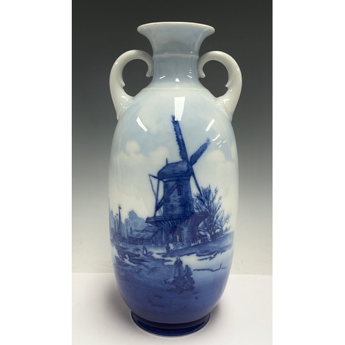 77 - A Rosenthal porcelain two handled ovoid vase, printed in blue and white with a river, barges and win... 