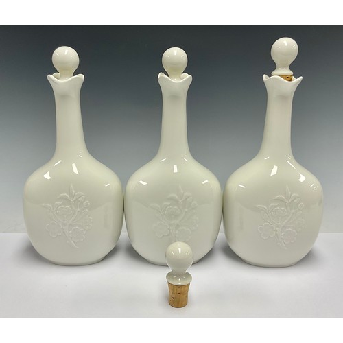 85 - A set of three Royal Copenhagen decanters and stoppers, glazed throughout in gloss white, number 449... 