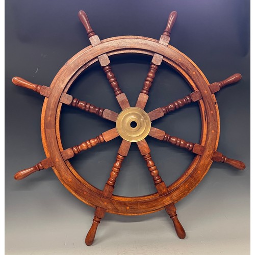 104 - A contemporary hardwood and brass stained ship's wheel, approx. 91.5cm wide