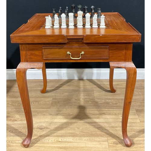 107 - A contemporary games table, removable square top inlaid for chess, the verso with baize, enclosing a... 