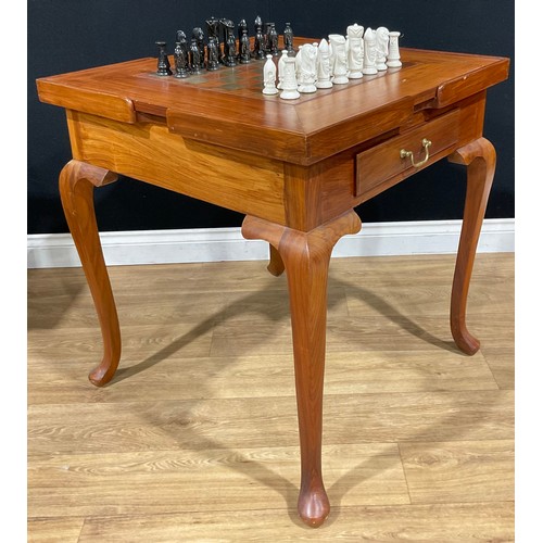 107 - A contemporary games table, removable square top inlaid for chess, the verso with baize, enclosing a... 