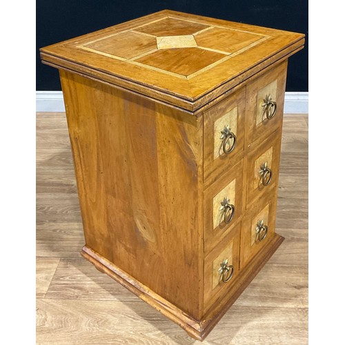 109 - An oak chest of drawers, of small proportions, the overhanging moulded cornice above three pairs of ... 