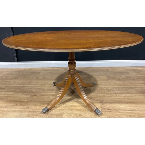 115 - A Regency style breakfast or dining table, oval tilting top, 76cm high, 140cm long, 92cm wide