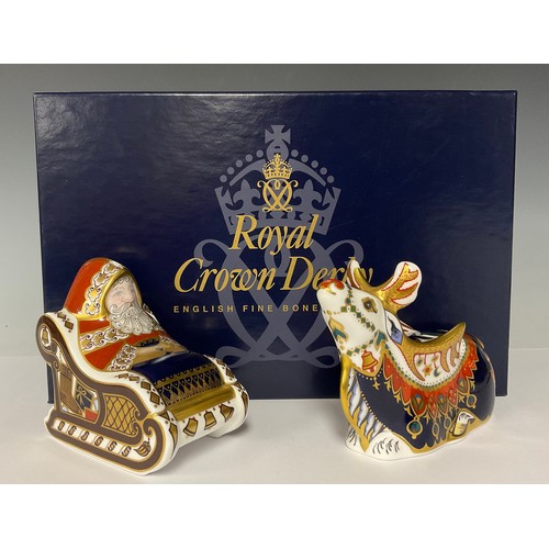 64 - A pair of Royal Crown Derby paperweights, Father Christmas in Sleigh and Reindeer, gold stoppers, Sa... 