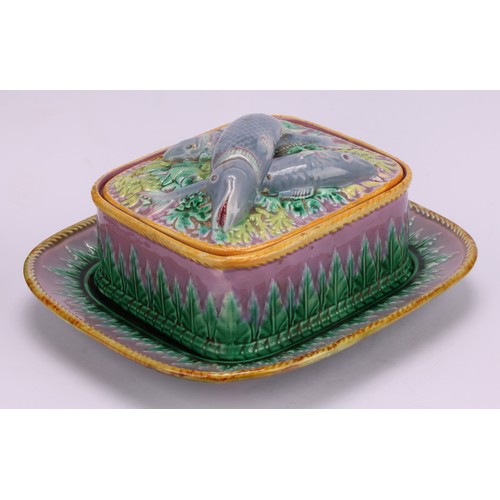 34 - A George Jones majolica rounded rectangular sardine box and stand, the cover surmounted by fish, gla... 
