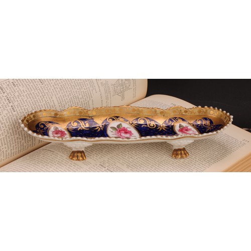 101 - An English porcelain shaped oval pen tray, the field with three oval reserves painted with pink rose... 