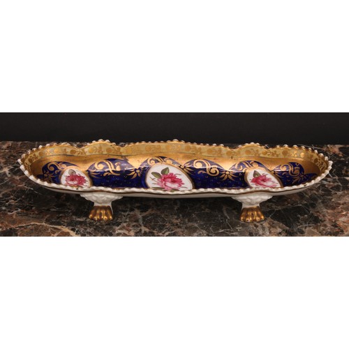 101 - An English porcelain shaped oval pen tray, the field with three oval reserves painted with pink rose... 