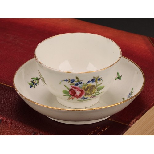 70 - A Caughley teabowl and saucer, painted in polychrome with Back to Back Roses pattern, gilt line rims... 