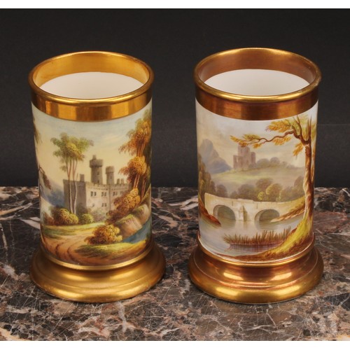 86 - A pair of English porcelain cylindrical spill vases, each painted with a continuous lakeside landsca... 