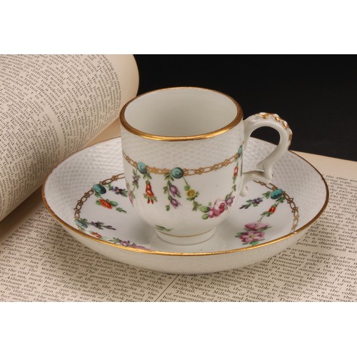 68 - A Bristol coffee cup and saucer, basket weave moulded border, enamelled with polychrome swags suspen... 