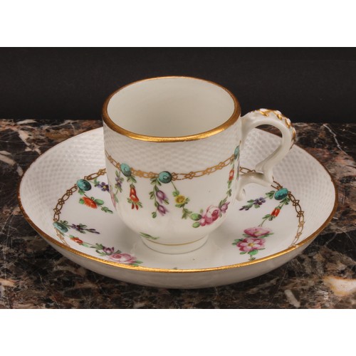 68 - A Bristol coffee cup and saucer, basket weave moulded border, enamelled with polychrome swags suspen... 