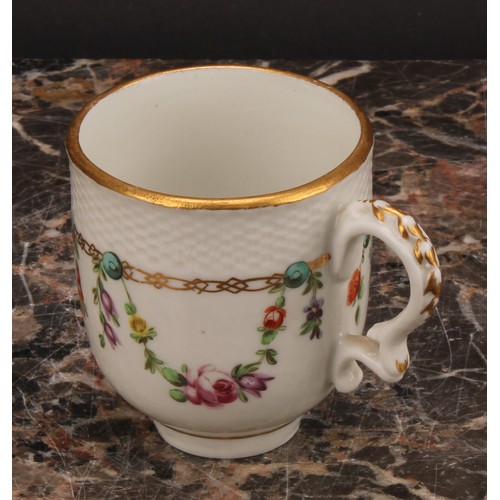 68 - A Bristol coffee cup and saucer, basket weave moulded border, enamelled with polychrome swags suspen... 