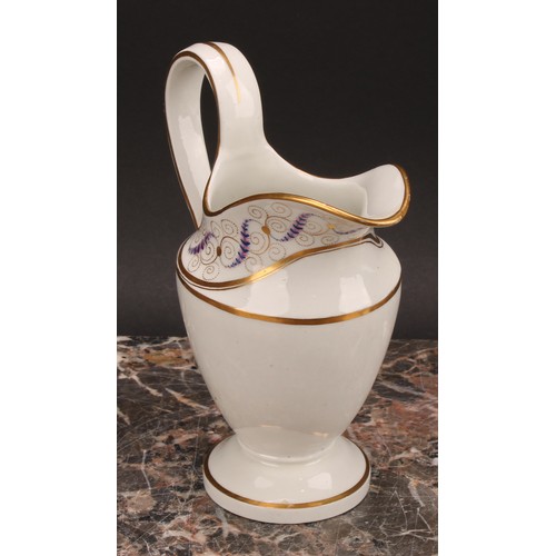 94 - A Thomas Wolfe Factory Z helmet shaped cream jug, painted with flowers within an oval gilt cartouche... 