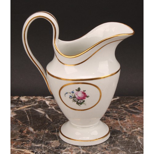 94 - A Thomas Wolfe Factory Z helmet shaped cream jug, painted with flowers within an oval gilt cartouche... 