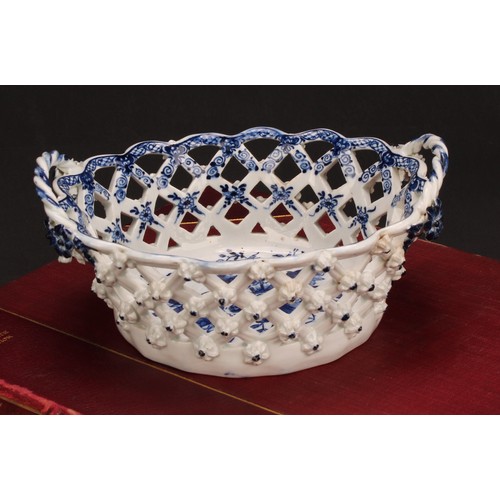 103 - An Lowestoft Pine Cone pattern two-handled oval basket, central oval reserve painted in underglaze b... 