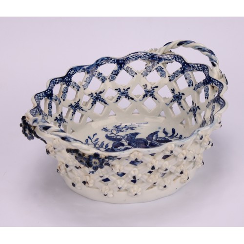 103 - An Lowestoft Pine Cone pattern two-handled oval basket, central oval reserve painted in underglaze b... 