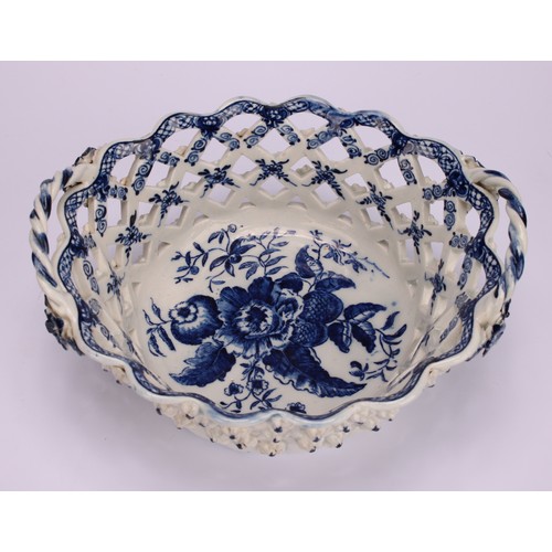 103 - An Lowestoft Pine Cone pattern two-handled oval basket, central oval reserve painted in underglaze b... 