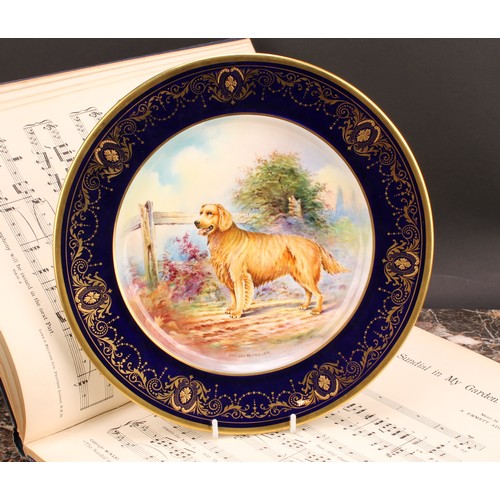 97 - An Aynsley circular plate, painted by J. Shaw, signed to verso, with a Golden Retriever by a fence, ... 