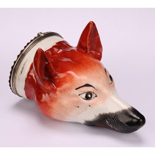 92 - A Staffordshire pottery novelty stirrup cup, modelled as a fox mask, naturalistically painted, silve... 