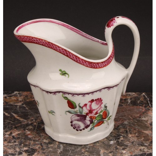 105 - A Newhall helmet shaped cream jug, painted with scattered flowers, the interior with stylised floral... 