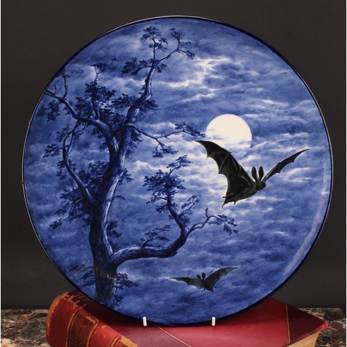 123 - A Royal Worcester Aesthetic Movement circular charger, painted with bats against a moonlit sky, in s... 