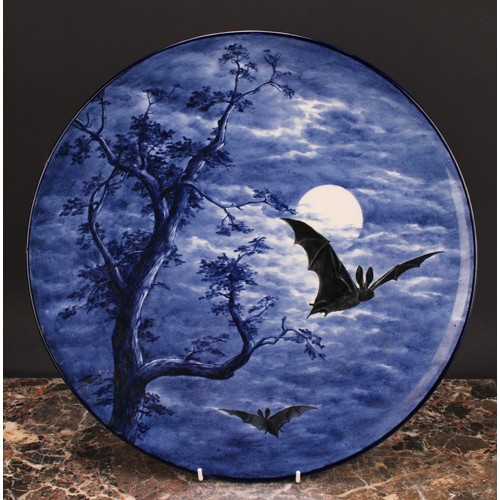 123 - A Royal Worcester Aesthetic Movement circular charger, painted with bats against a moonlit sky, in s... 